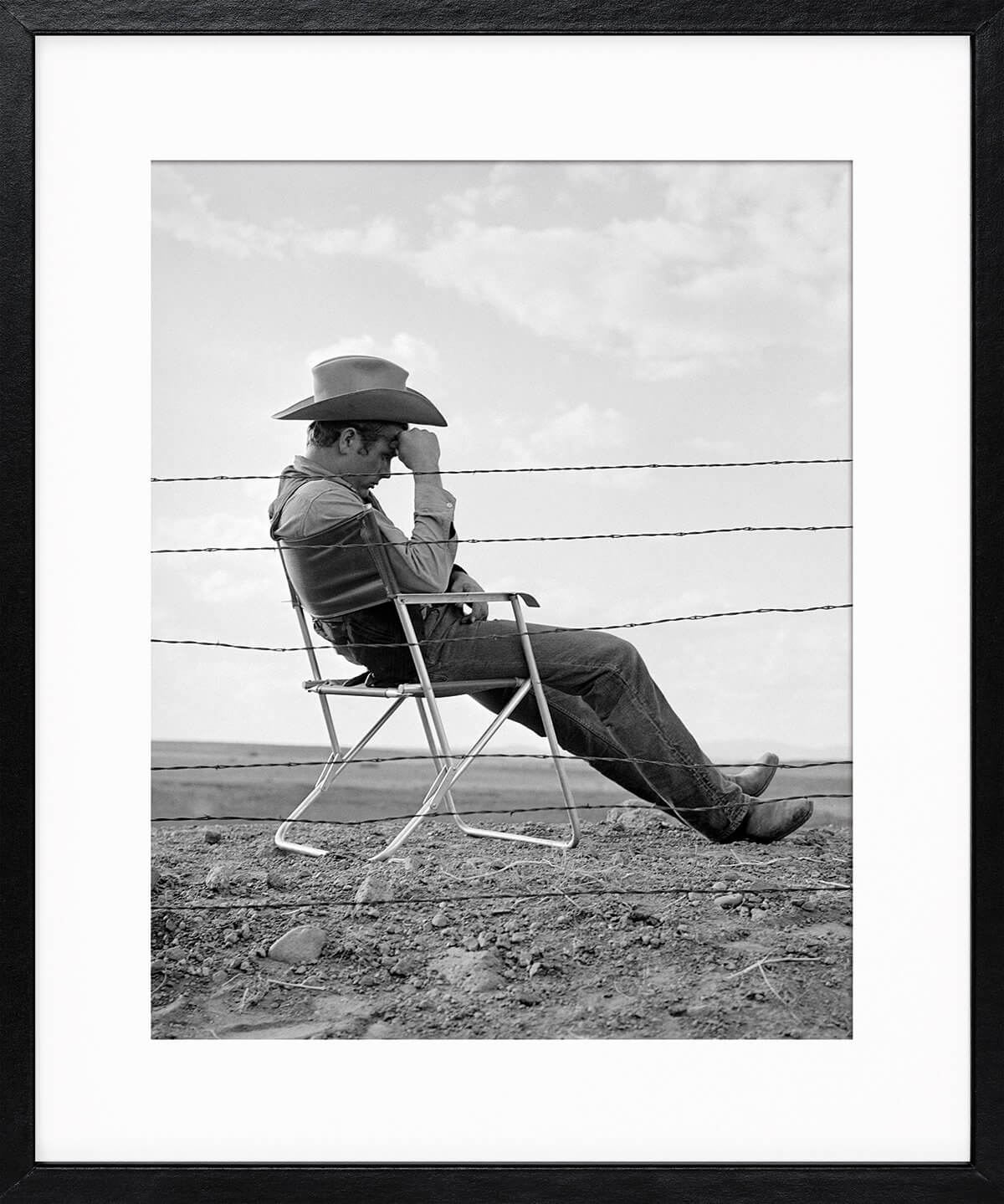 Frank Worth: James Dean seated behind Fence Set of Giant 1955