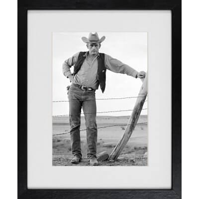 Frank Worth: James Dean standing at fence Set of Giant